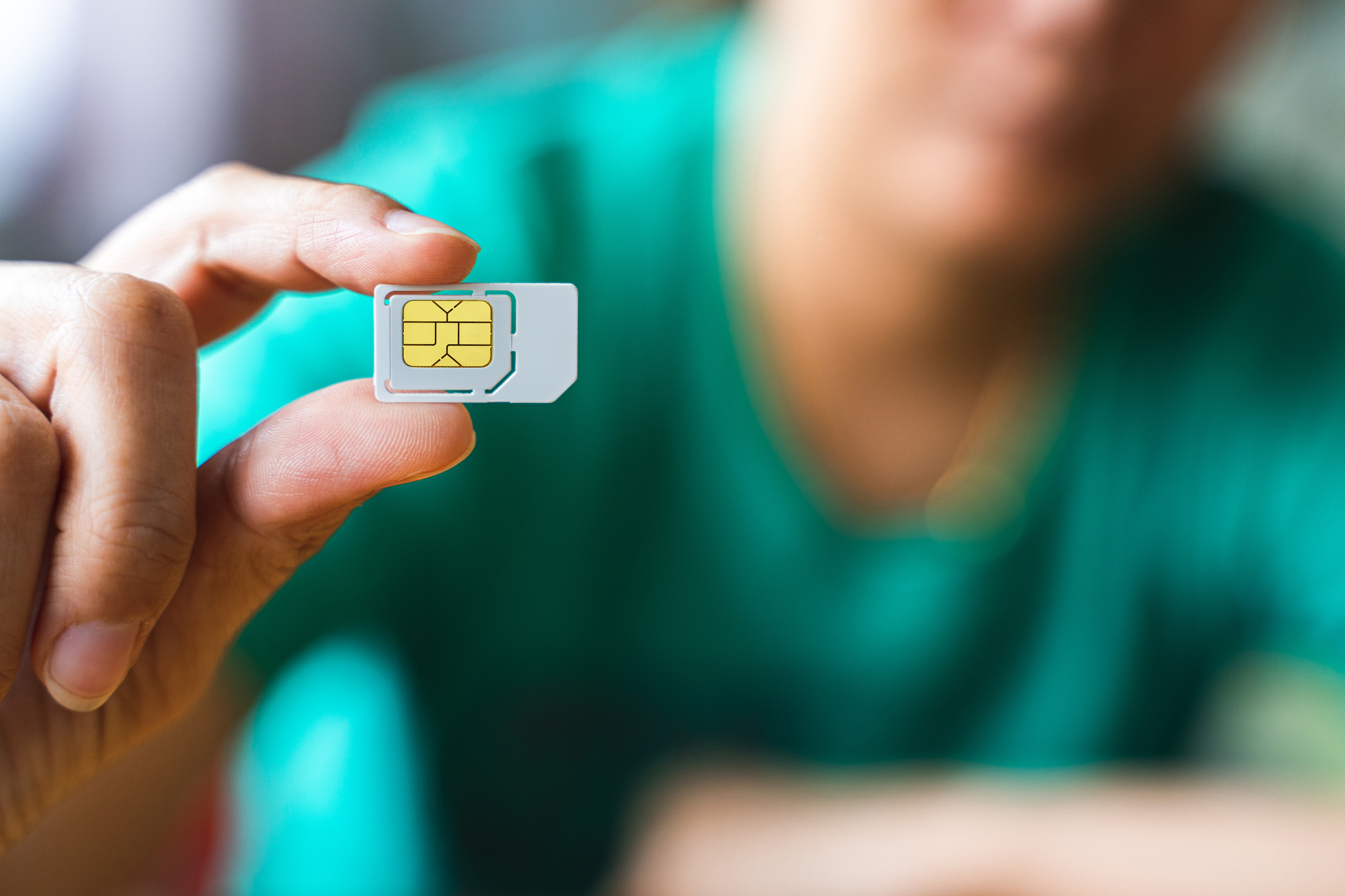 a photo of a hand holding a sim card