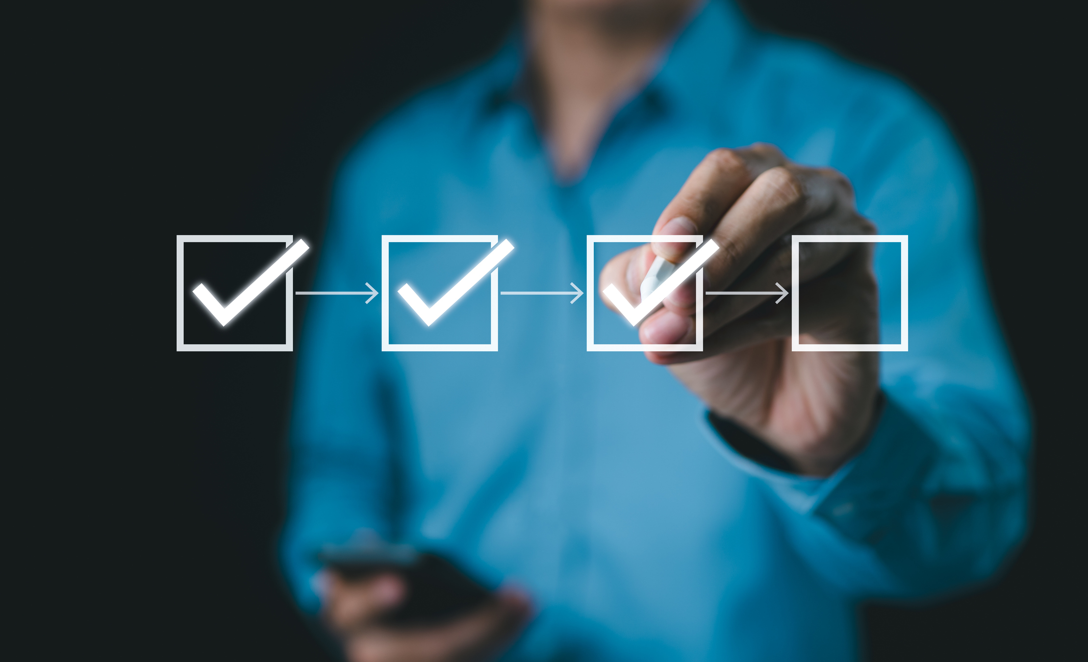 a man completing a task list using a tick box list