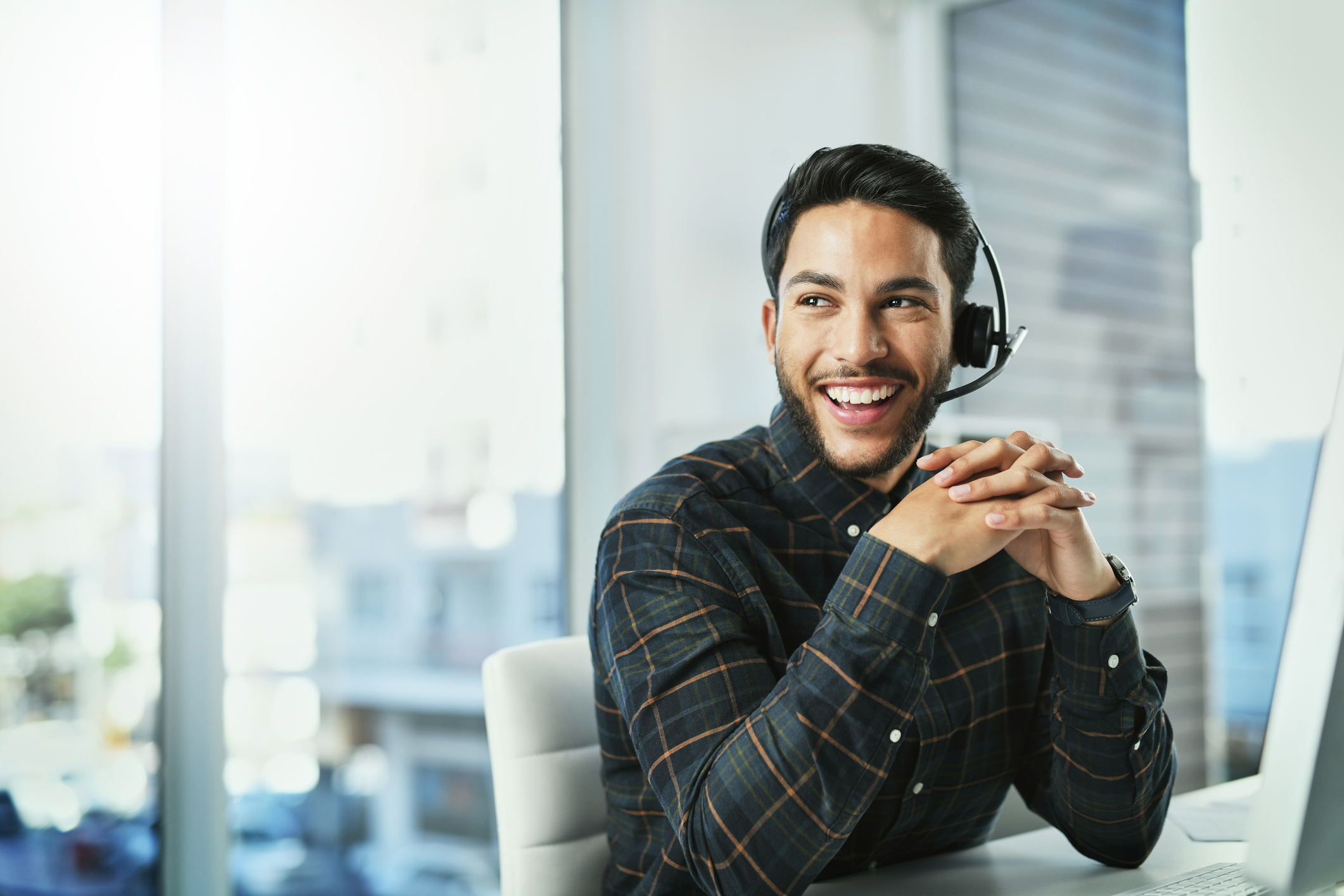 Portrait of a handsome young call centre agent working in his office