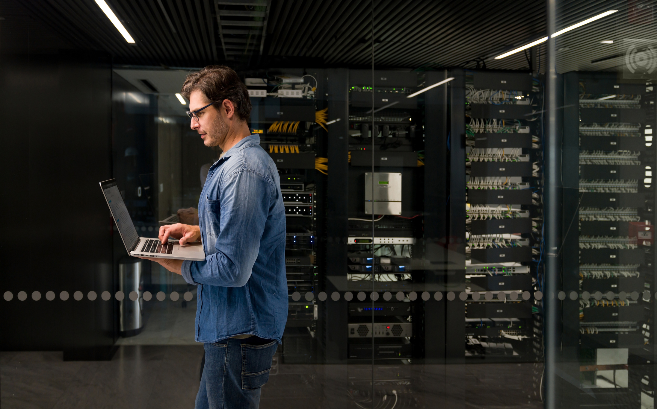 man walking the hallways of a data centre showing different services on offer
