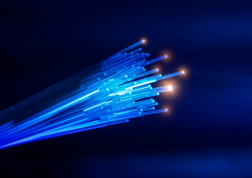 the insides of a fibre optic cable showing each strand with a light at the end of each strand to portray speed